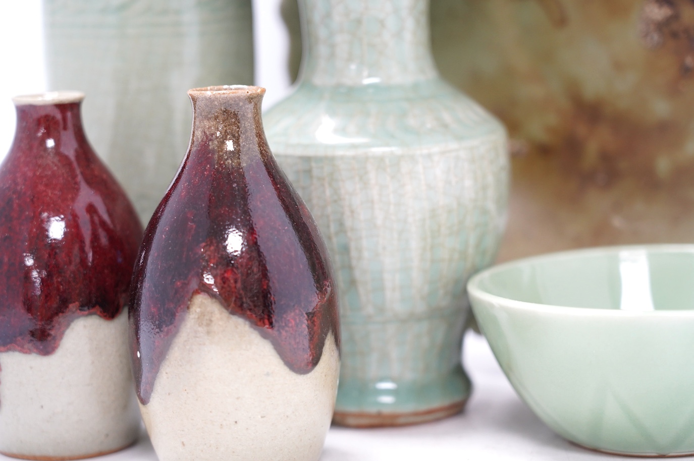 Four items of Chinese celadon porcelain and a similar pair of vases, tallest 19.5cm high. Condition - bottle vase and small pottery vase chipped, the others good